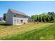 The rear exterior overlooks expansive yard, with mature trees in a tranquil setting at 5102 Candleglow Ct, Indian Trail, NC 28079