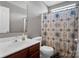 Bright bathroom features a large vanity, toilet, and shower with patterned shower curtain at 5102 Candleglow Ct, Indian Trail, NC 28079