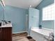 This bathroom includes a soaking tub, updated fixtures, and light blue walls at 5102 Candleglow Ct, Indian Trail, NC 28079