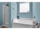 This bathroom includes a soaking tub, a shower, and light blue walls at 5102 Candleglow Ct, Indian Trail, NC 28079