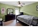 This bedroom features dark furniture with a ceiling fan and a double hung window at 5102 Candleglow Ct, Indian Trail, NC 28079