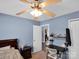 This bedroom has light blue walls and features a ceiling fan and room to work from home at 5102 Candleglow Ct, Indian Trail, NC 28079