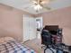 Cozy bedroom features a ceiling fan, closet, and study space with natural light at 5102 Candleglow Ct, Indian Trail, NC 28079