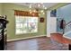 Inviting dining area featuring hardwood floors, modern lighting, and a large window at 5102 Candleglow Ct, Indian Trail, NC 28079