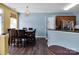 Open dining room boasts modern light fixture and blends seamlessly into the adjacent kitchen at 5102 Candleglow Ct, Indian Trail, NC 28079