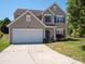 Charming two-story home with a well-maintained lawn, attached garage, and inviting front entrance at 5102 Candleglow Ct, Indian Trail, NC 28079