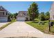 Traditional two-story home with a long driveway, attached garage, and well-manicured front lawn at 5102 Candleglow Ct, Indian Trail, NC 28079
