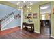Bright foyer featuring wood floors, stylish lighting, and views into the dining room and staircase at 5102 Candleglow Ct, Indian Trail, NC 28079