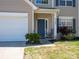 Inviting front entrance with a rocking chair and neat landscaping, adjacent to the garage at 5102 Candleglow Ct, Indian Trail, NC 28079