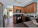Well-equipped kitchen features stainless steel refrigerator, oak cabinets, and tile backsplash at 5102 Candleglow Ct, Indian Trail, NC 28079