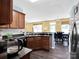 Functional kitchen with dark cabinets, modern appliances, and an adjacent dining area at 5102 Candleglow Ct, Indian Trail, NC 28079