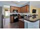 Efficient kitchen with dark cabinetry, modern appliances, and ample counter space at 5102 Candleglow Ct, Indian Trail, NC 28079