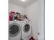 Functional laundry room with washer, dryer, and shelving for organizing laundry essentials at 5102 Candleglow Ct, Indian Trail, NC 28079
