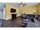 Comfortable living room features a fireplace, TV, neutral paint, and wood flooring at 5102 Candleglow Ct, Indian Trail, NC 28079