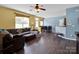 Bright living space features a large sofa, modern lighting, and an open-concept dining area at 5102 Candleglow Ct, Indian Trail, NC 28079