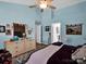 This bedroom includes a tufted headboard, light floors and a walk in closet at 5102 Candleglow Ct, Indian Trail, NC 28079