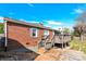 View of backyard with wooden deck on a brick house under a bright blue sky at 534 Georgia Ave, Statesville, NC 28677