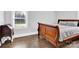 Bright bedroom with hardwood floors, a large window, and stylish wooden furniture at 534 Georgia Ave, Statesville, NC 28677