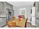 Open kitchen and dining area with stainless steel refrigerator and stacked washer/dryer at 534 Georgia Ave, Statesville, NC 28677