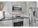 Updated kitchen with stainless steel appliances, tiled backsplash, and modern cabinetry at 534 Georgia Ave, Statesville, NC 28677