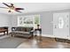 Inviting living room featuring hardwood floors, large window, ceiling fan, and comfortable seating at 534 Georgia Ave, Statesville, NC 28677