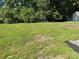 Expansive backyard featuring lush green grass and some trees creating a private outdoor space at 6239 Burmith Ave, Charlotte, NC 28269