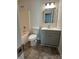 Bathroom with shower-tub combo, gray vanity with modern light fixture at 6239 Burmith Ave, Charlotte, NC 28269