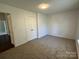 Neutrally painted bedroom offers generous space, plush carpeting, and natural light at 6239 Burmith Ave, Charlotte, NC 28269