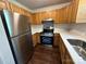 Modern kitchen equipped with stainless steel appliances, wood cabinets, and efficient design at 6239 Burmith Ave, Charlotte, NC 28269