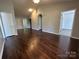 An airy living room boasts wood floors and neutral walls, ready for your personal touch at 6239 Burmith Ave, Charlotte, NC 28269