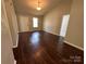 Sunlit living room featuring wood floors, neutral walls, and an inviting, spacious feel at 6239 Burmith Ave, Charlotte, NC 28269