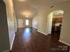 Spacious living area with wood flooring, arched doorways, and a bright, inviting atmosphere at 6239 Burmith Ave, Charlotte, NC 28269
