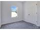 Bedroom featuring neutral walls, plush gray carpeting, and a bright window offering natural light at 6549 Wesbrook Dr, Charlotte, NC 28214