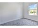 Bedroom featuring neutral walls, plush gray carpeting, and a bright window offering natural light at 6549 Wesbrook Dr, Charlotte, NC 28214