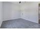 Cozy bedroom features neutral walls, gray carpeting, and a door to the hallway at 6549 Wesbrook Dr, Charlotte, NC 28214