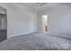 Spacious main bedroom with tray ceilings, gray carpeting, and two entrances to ensuite bathrooms at 6549 Wesbrook Dr, Charlotte, NC 28214