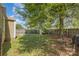 Spacious fenced backyard with lush greenery, a storage shed, and ample space for outdoor activities at 665 Melbourne Ct, Charlotte, NC 28209