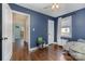 Bedroom featuring hardwood floors, a ceiling fan, and easy access to an adjacent room at 665 Melbourne Ct, Charlotte, NC 28209