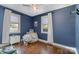 This bedroom features hardwood floors, two windows, and a ceiling fan at 665 Melbourne Ct, Charlotte, NC 28209