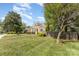 Charming single story home featuring a well-maintained lawn, mature trees, and inviting curb appeal at 665 Melbourne Ct, Charlotte, NC 28209