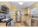 Modern kitchen featuring stainless steel appliances, granite countertops, and ample cabinet storage at 665 Melbourne Ct, Charlotte, NC 28209