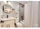 Stylish bathroom featuring sleek fixtures, modern vanity, and a shower with a tub, designed for relaxation and convenience at 700 Cooper Dr, Charlotte, NC 28210