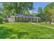 Beautiful single-story home with lush green lawn and mature landscaping at 700 Cooper Dr, Charlotte, NC 28210