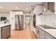 Open kitchen layout with stainless steel appliances, custom cabinetry, and hardwood floors at 700 Cooper Dr, Charlotte, NC 28210