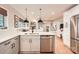 A modern kitchen featuring white cabinets, stainless steel appliances, and elegant pendant lighting at 700 Cooper Dr, Charlotte, NC 28210
