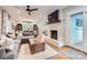 Spacious living room featuring a gray sofa, hardwood floors, and a brick fireplace at 700 Cooper Dr, Charlotte, NC 28210