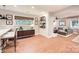 Open-concept living room featuring a bar area, view into living room, and beautiful hardwood floors at 700 Cooper Dr, Charlotte, NC 28210