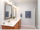 Bathroom featuring a double vanity with framed mirrors, and updated fixtures at 7515 Shadowstone Dr, Charlotte, NC 28270