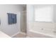 Clean bathroom with a combined shower and tub, framed with white tile at 7515 Shadowstone Dr, Charlotte, NC 28270
