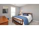 Cozy bedroom with wood furniture, a comfortable bed, and a view from the bright window at 7515 Shadowstone Dr, Charlotte, NC 28270